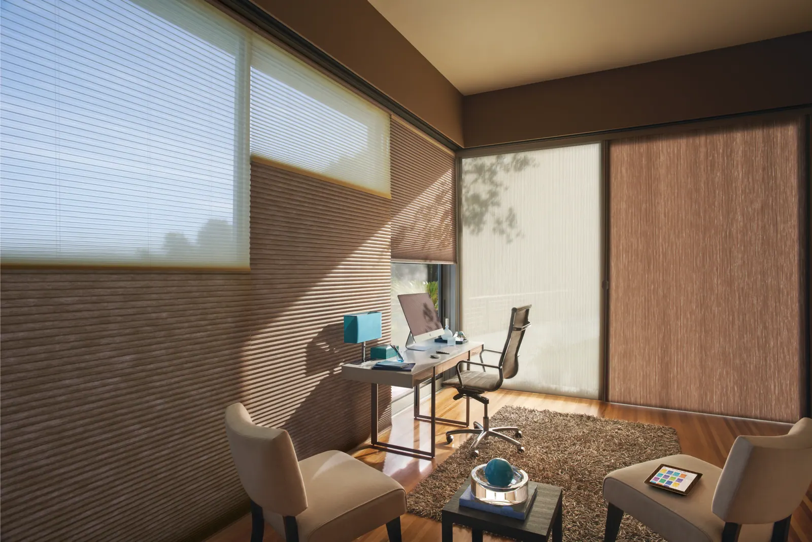 Cellular honeycomb shades filtering daylight in a home office